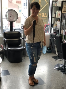 Young woman with breast cancer shaving head